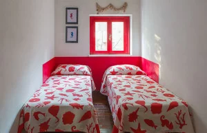Twin beds with red drawings