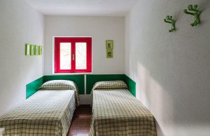 Green twin beds of triple bedroom