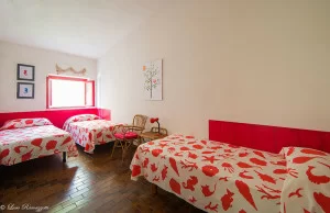 Triple bedroom with red sea drawings