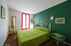 Double bedroom with green decorations